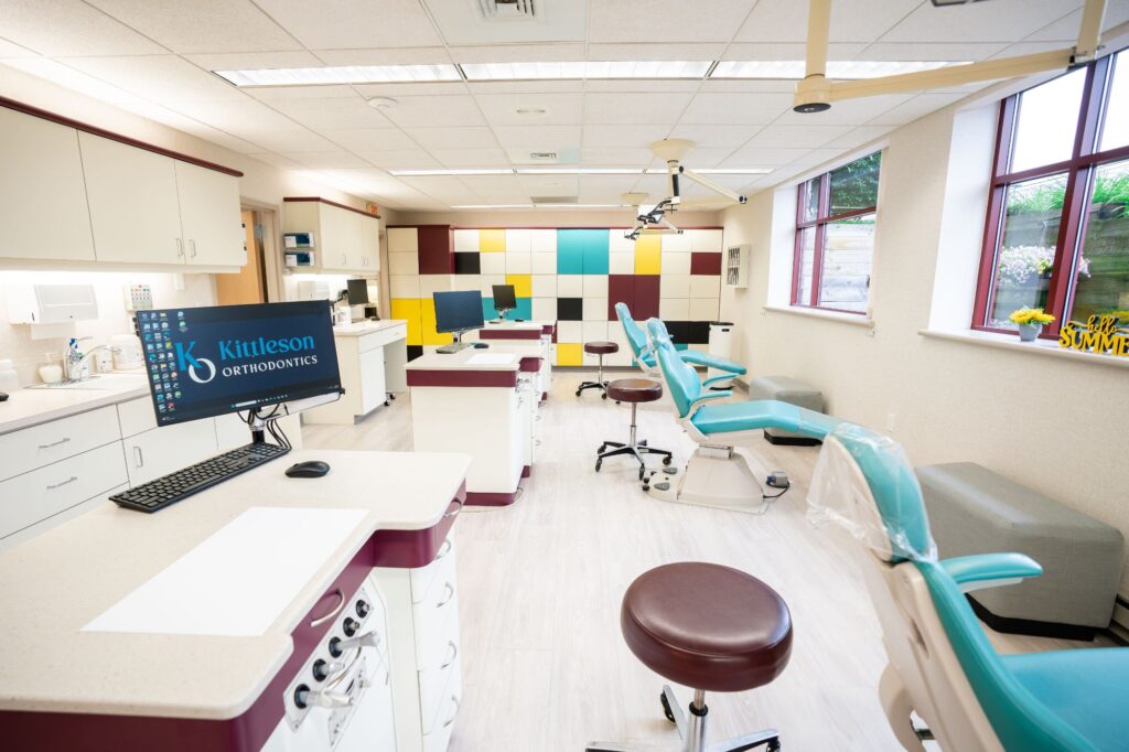 Modern orthodontic treatment area at Kittleson Orthodontics in Mequon, featuring dental chairs, workstations, and a welcoming environment for patients seeking braces and orthodontic care.