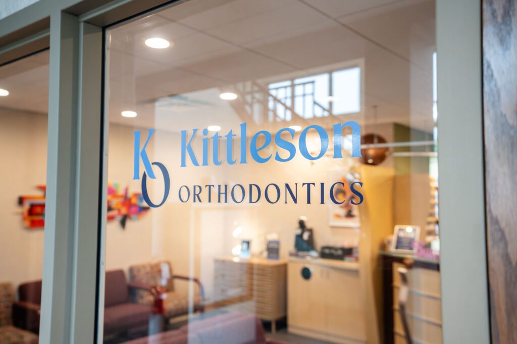 Kittleson Orthodontics office entrance featuring modern decor, comfortable waiting area, and branding for Mequon orthodontic services.